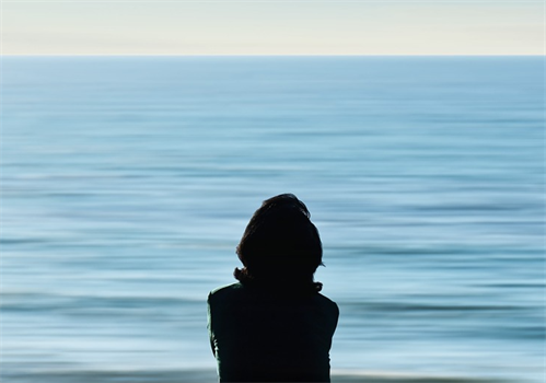 Silhouette of woman by the sea