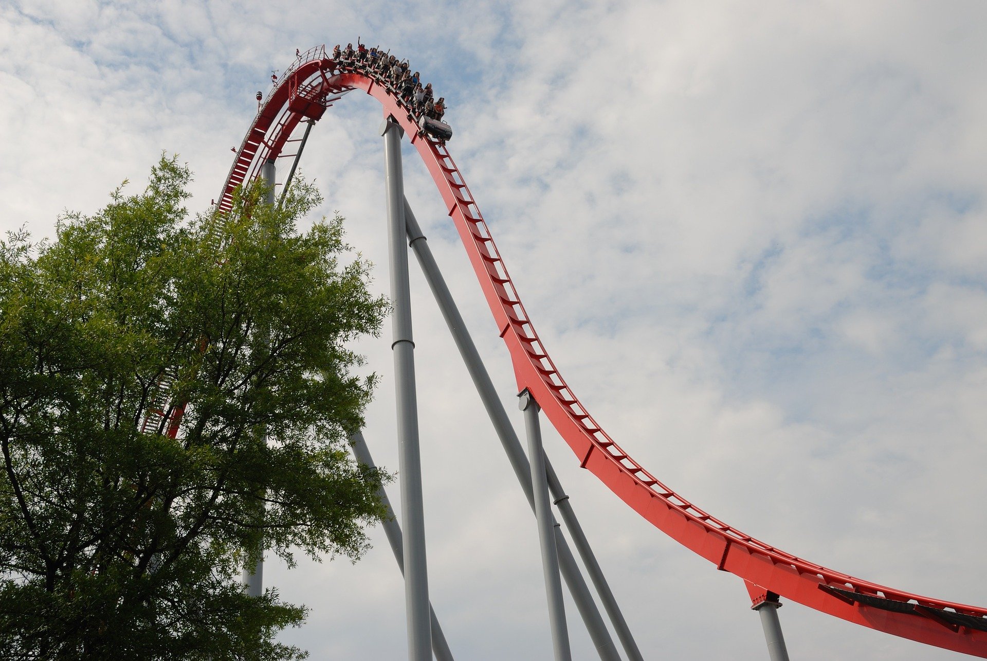 Image of a rollercoaster at the top of a big downward slope about to roll down it
